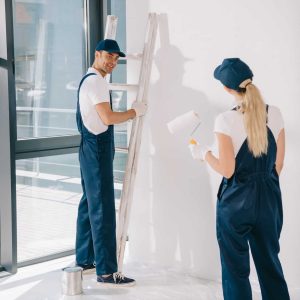 handsome-painter-standing-near-ladder-while-pretty-colleague-holding-paint-roller.jpg