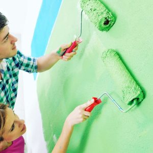 happy-couple-paint-wall-at-new-home.jpg